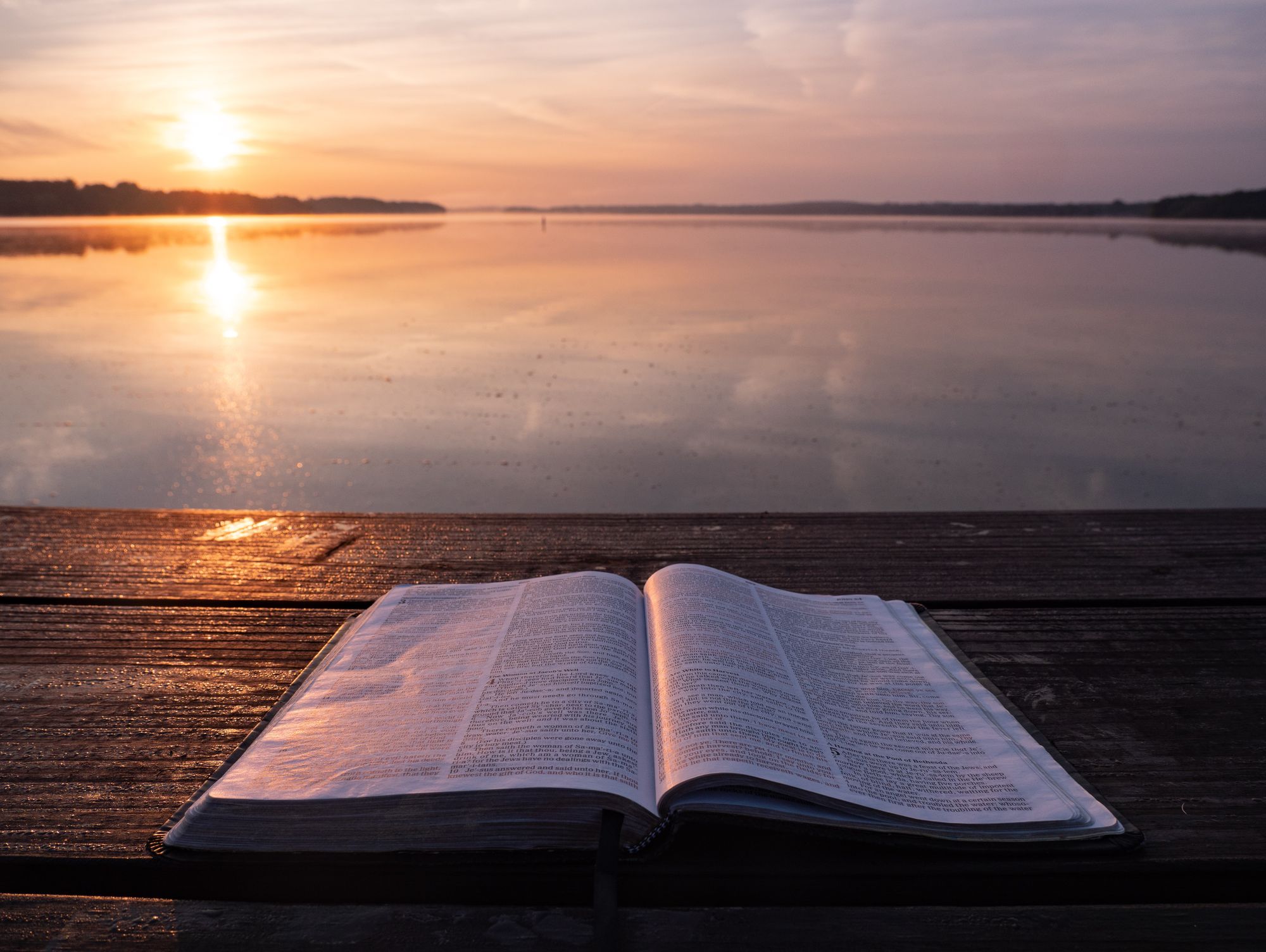 Background image of of a bible at sunset